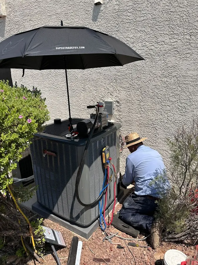 HVAC technician performing outdoor AC maintenance in Las Vegas